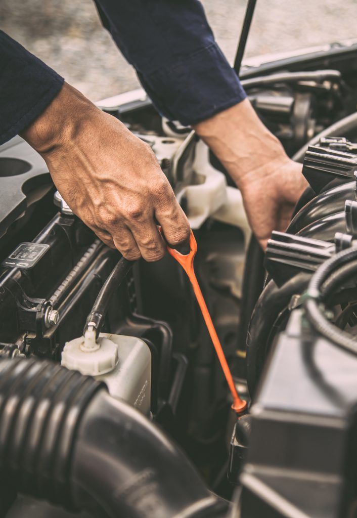 Mechanic checking vehicle engine oil levels - MOT & SERVICING LIVERPOOL